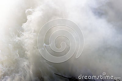 White thick smoke of smoldering hay. Stock Photo