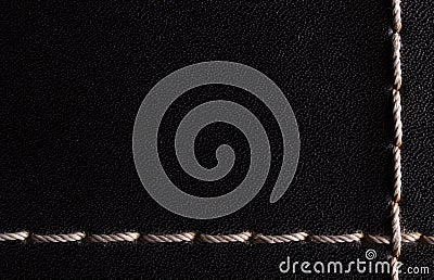 White thread stitching on black leather. Stock Photo