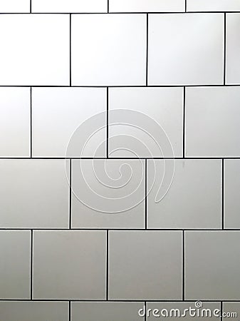 White tile ceramics of a bathroom wall Stock Photo