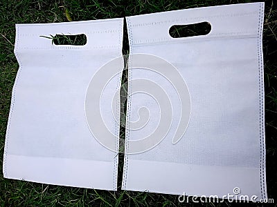 2 White Color s cut Fabric Eco Bags Cloth Shopping Sack On Green Grass Stock Photo