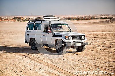 White toyota car driving in desert of Hurghada, Egypt Editorial Stock Photo