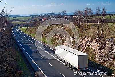 White truck driving along the asphalt road countryside Stock Photo