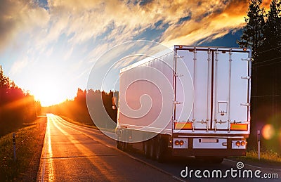 White truck on a road in the evening Stock Photo