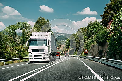 White Truck Or Tractor Unit, Prime Mover, Traction Unit In Motion On Road, Freeway. Asphalt Motorway Highway Against Stock Photo