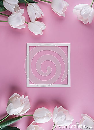 White tulips flowers and sheet of paper over light pink background. Card for Mothers day, 8 March, Happy Easter.Waiting for spring Stock Photo