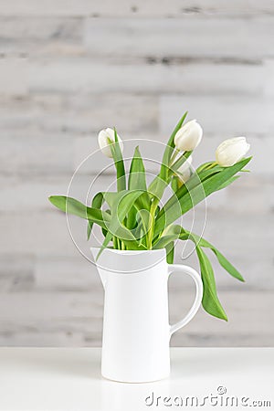 White tulips in a white pitcher Stock Photo