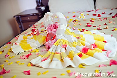 White two towel swans and red rose on the bed in Honey moon suit Stock Photo