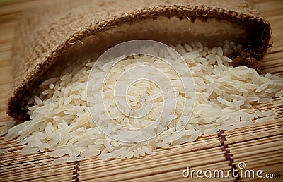 White uncooked rice in small sack Stock Photo
