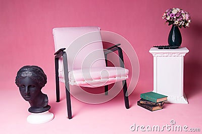 White upholstered chair on a pink background Stock Photo