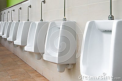 White urinal in men`s bathroom. Stock Photo