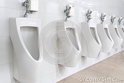 White urinal in men`s bathroom. Stock Photo