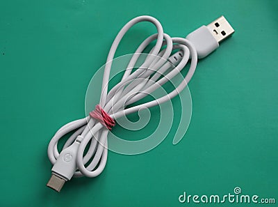 White usb cable, isolated on green background, computer peripherals connector Stock Photo