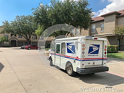White USPS truck stops at apartment building complex on sunny da Editorial Stock Photo