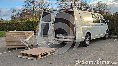 Pallets of boxes being being packed into a white van Stock Photo