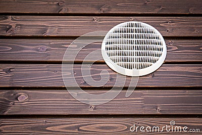 White ventilation grill on a wooden background, building facade Stock Photo