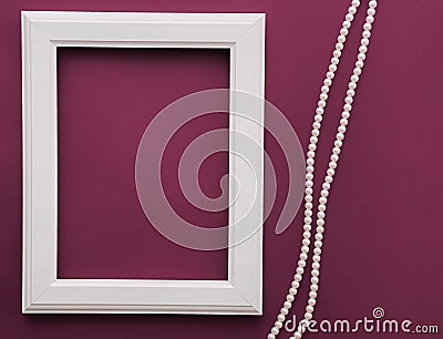 White vertical art frame and pearl jewellery on purple background as flatlay design, artwork print or photo album Stock Photo