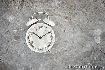 White vintage alarm clock on the gray background. Productivity control and task planning concept Stock Photo