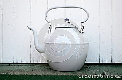 A white vintage enamel kettle on a white background Stock Photo