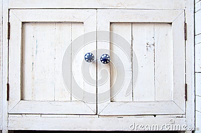 White vintage wooden cupboard with blue knobs Stock Photo