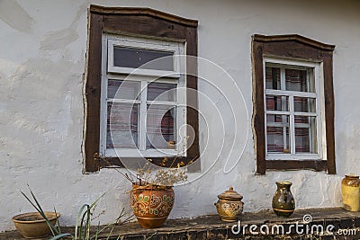 White wall of old clay house with two windows with wooden frame Stock Photo