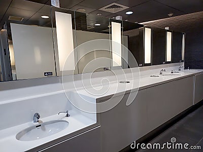 White wash basin with faucet and mirror, shot in toilet space at MRT station in Taipei, Taiwan. Editorial Stock Photo