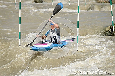 White water kayak athlete racing through a downstream slalom gate Stock Photo