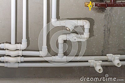 White water supply new plastic pipes on the concrete wall of the house Stock Photo