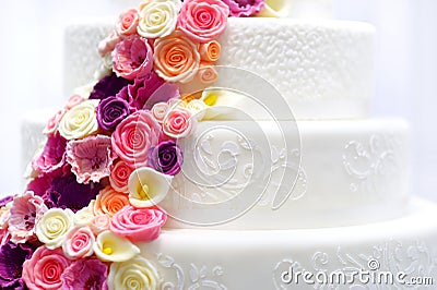 White wedding cake decorated with sugar flowers Stock Photo