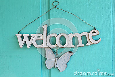 White welcome sign with a butterfly Stock Photo