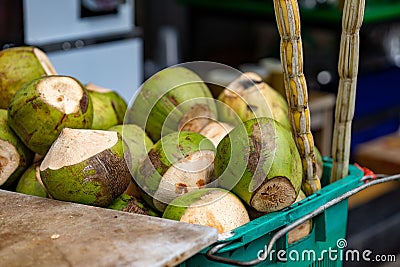 a basket filled with fresh cut coconuts sitting on a counter Stock Photo