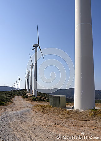 White wind turbines against the blue sky on the Greek island of Evia in Greece Stock Photo