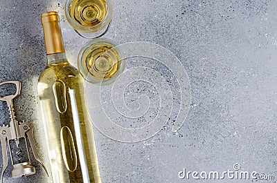 White wine in glass wine glasses, corkscrew, a bottle of wine. Blue background. Copy space. Flat lay Stock Photo