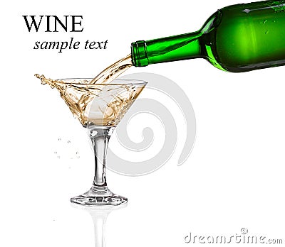 White wine pouring from the bottle intro the glass Stock Photo