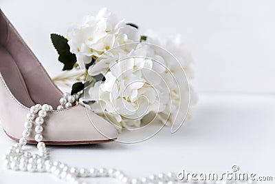 white womens boat Shoe, pearl, necklace, flower, hydrangea, shoes Stock Photo