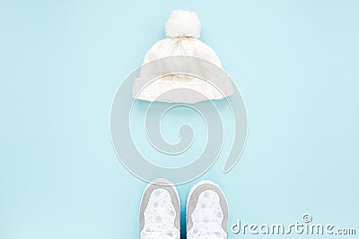 White women winter the boots and hat, glasses isolated on blue background. Flat lay, top view trendy fashion feminine Stock Photo