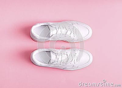 White womens gumshoes on a pink background. Stock Photo