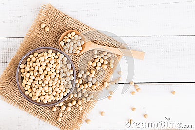 White wood floor with wooden cup with soybean,top view and copyspace,soybeans in wooden bowl with wooden spoon on table wooden Stock Photo