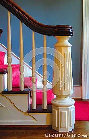 White wood staircase with tapered newel post Stock Photo