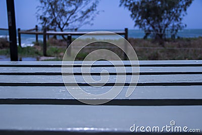 White Wood Table with Blurred Beach at Background Stock Photo