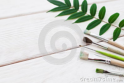 White wooden background with paintbrushes Stock Photo