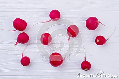 White wooden background with red radishes. Stock Photo