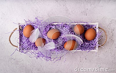 White wooden box with chicken eggs on white marble background top view flat lay Stock Photo