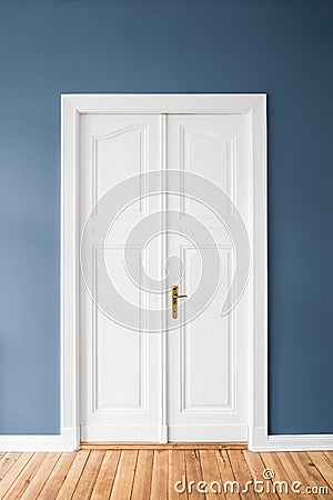 White wooden door, blue wall - Stock Photo