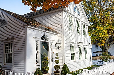 White Wooden House with a Traditional Green Wooden Door Stock Photo