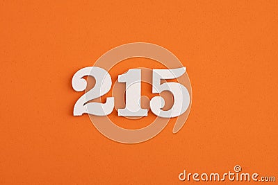 White wooden number 215 on eva rubber orange background Stock Photo