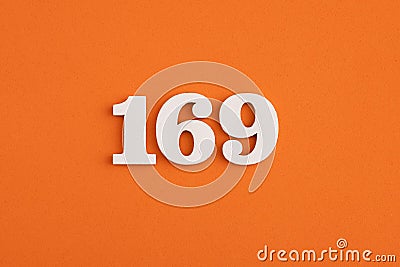 White wooden number 169 on eva rubber orange background Stock Photo