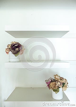 White Wooden Shelf with Vintage Style Flowerpots on White Wall Stock Photo