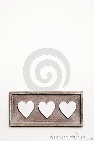 White wooden vintage background with three hearts. Stock Photo