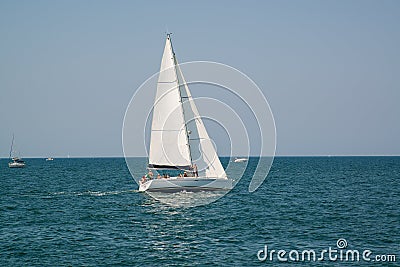 White yacht in the open azure sea near the resort of Rimini, Italy. Stock Photo