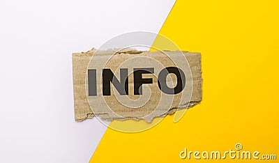 On a white and yellow background, brown torn cardboard with the text INFO Stock Photo